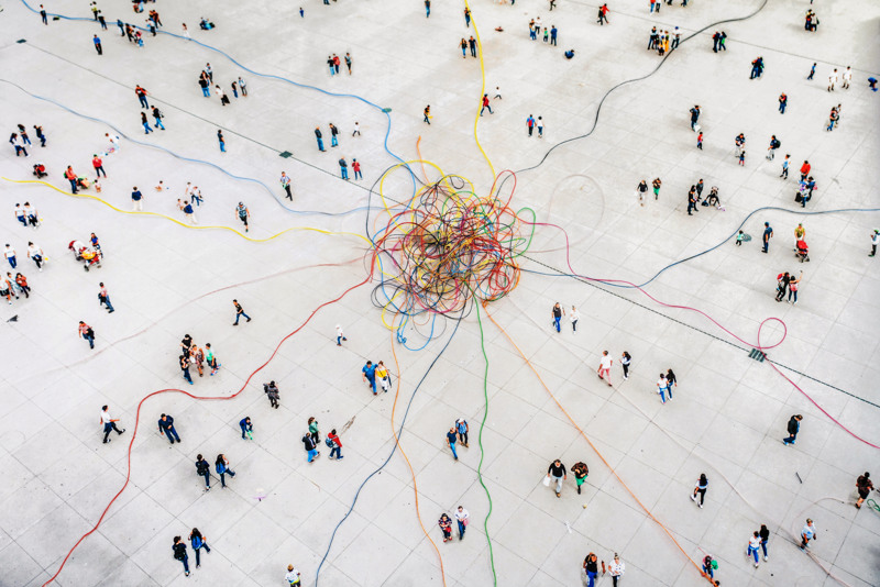 Aerial view of crowd connected by colorful lines